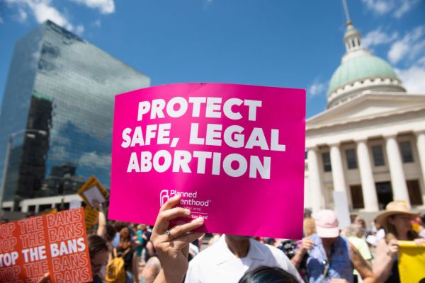 Protesters hold signs as they rally in support of Planned Parenthood and pro-choice and to protest a state decision that would effectively halt abortions by revoking the centers license to perform the procedure, near the Old Courthouse in St. Louis, Missouri, May 30, 2019. (Photo by SAUL LOEB / AFP)        (Photo credit should read SAUL LOEB/AFP/Getty Images)